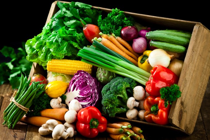 Wooden crate filled with fresh organic vegetables