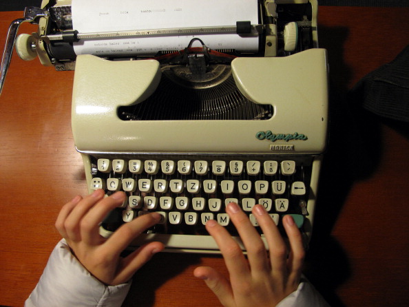 Typing in an old typewriter.