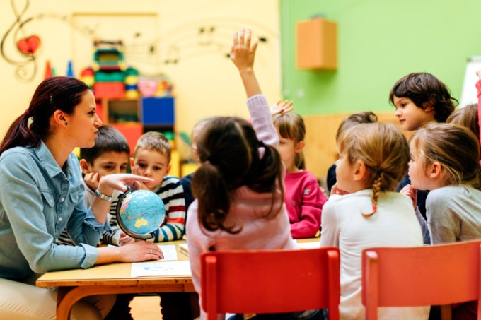 Preschool teacher and children in classroom