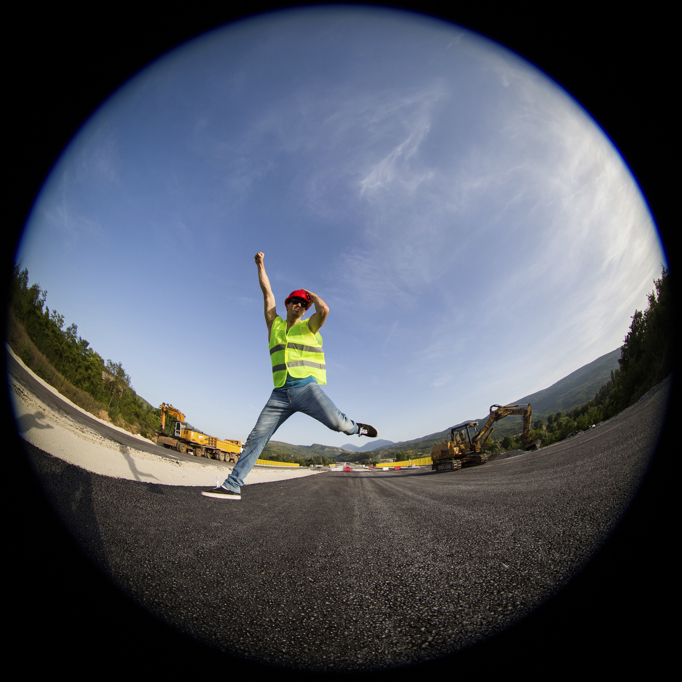 Construction worker smiling and jumping