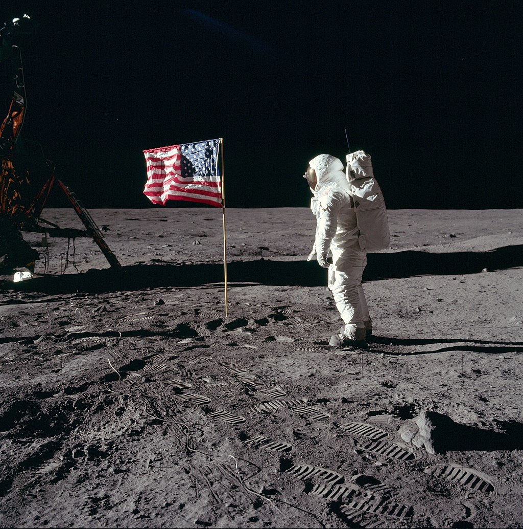Aldrin prestando continência à bandeira dos Estados Unidos.