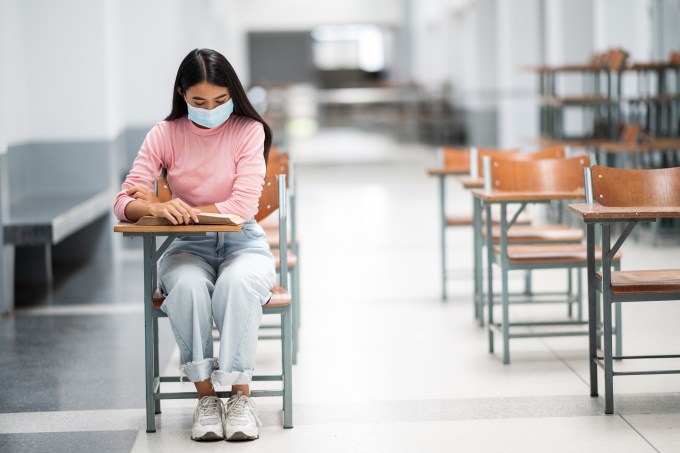 University female students sit spaced in the Social Distancing classroom to prevent communicable diseases.