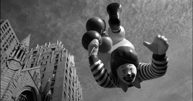 Fotografia de Pedro Meyer. Na foto, há um balão do palhaço do Mc Donalds no céu. Ao lado, está um prédio alto. A imagem está em preto e branco.