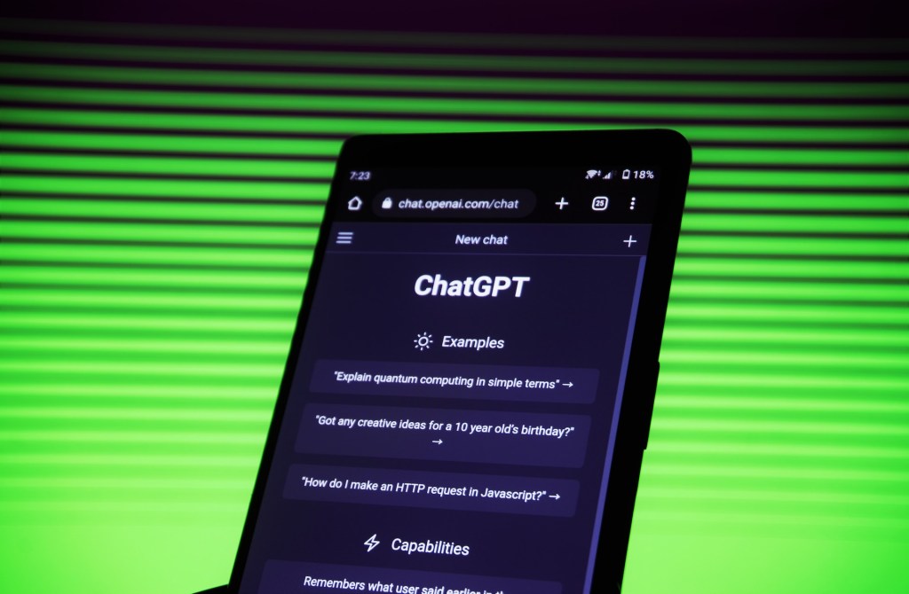 Tela de celular aberta na página do ChatGPT. Ao fundo, uma parede com luzes verdes.