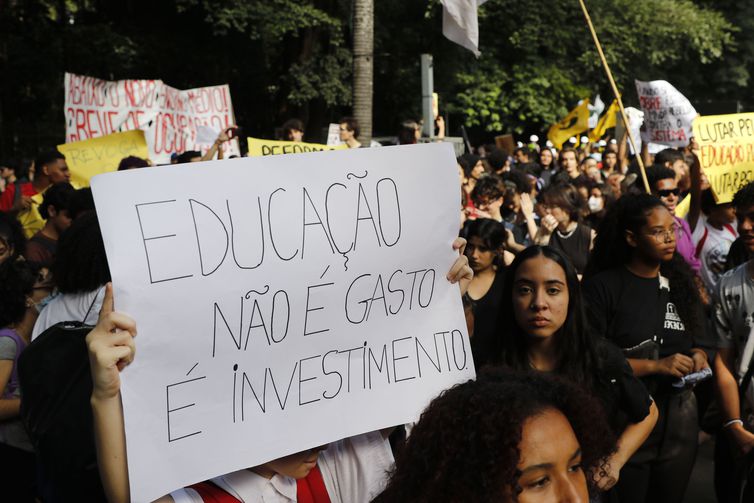 Estudante carrega cartaz escrito "Educação Não é gasto, é investimento" em protesto pela revogação do Novo ENsino Médio