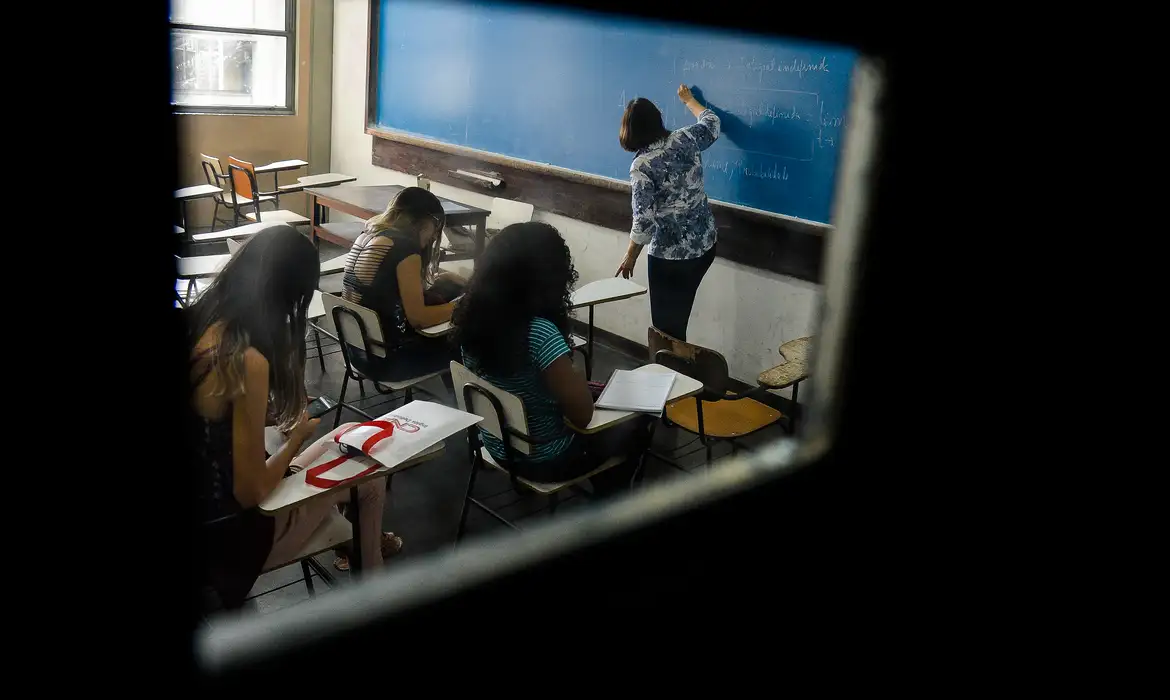 Estudantes na sala de aula vistos por uma janela